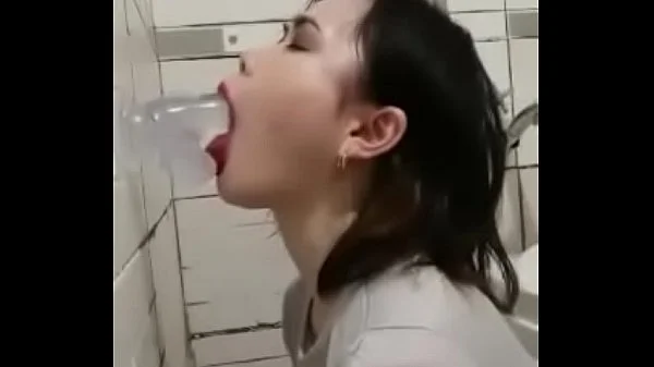 Asian deepthroating a dildo