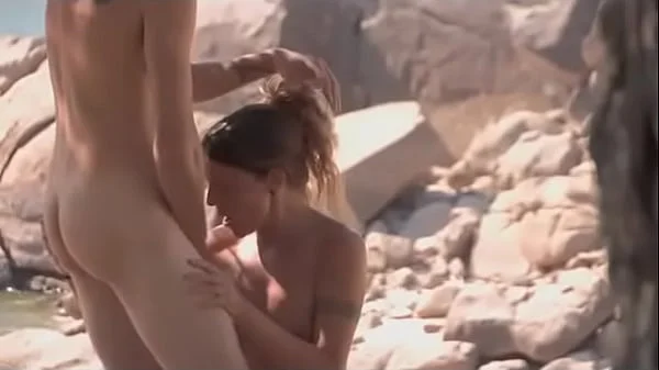 Horny MILF babe seduces a random guy at the nudist beach