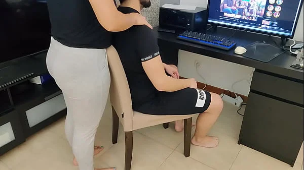 mature gives her stepson a handjob while watching porn